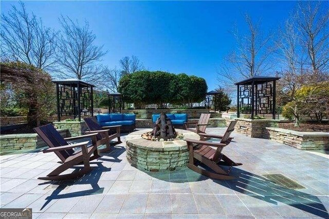 view of patio / terrace with a gazebo and a fire pit