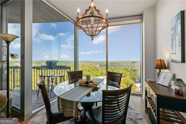 sunroom / solarium with a notable chandelier and plenty of natural light