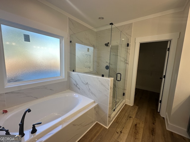 bathroom featuring hardwood / wood-style floors and shower with separate bathtub