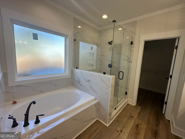 bathroom featuring hardwood / wood-style flooring and independent shower and bath