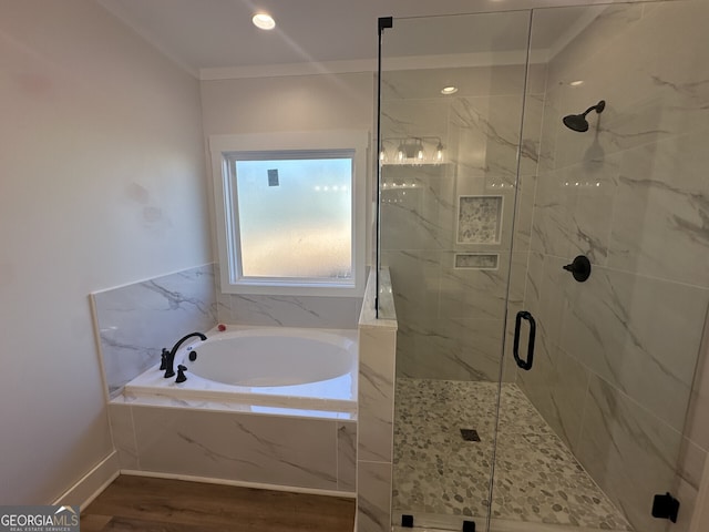 bathroom featuring shower with separate bathtub and hardwood / wood-style floors