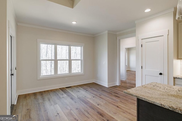 interior space featuring ornamental molding and light hardwood / wood-style floors