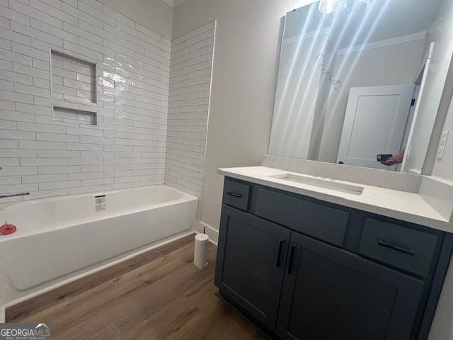 bathroom featuring hardwood / wood-style flooring, shower / bath combo, and vanity