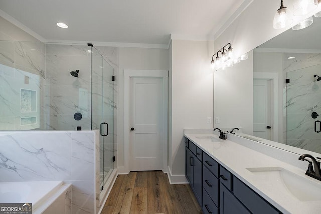 bathroom with shower with separate bathtub, crown molding, vanity, and hardwood / wood-style floors