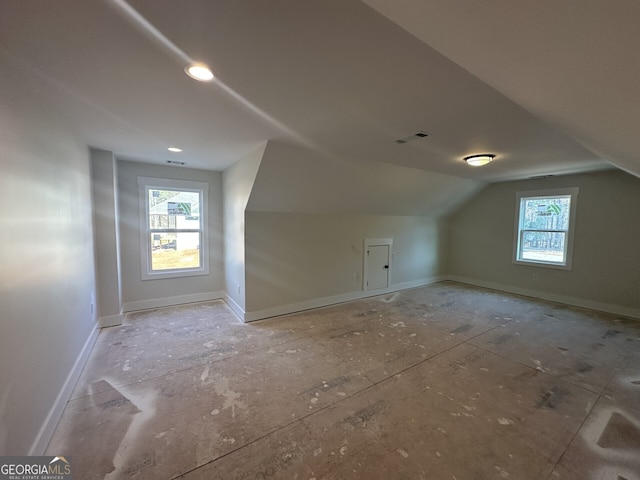 bonus room featuring vaulted ceiling and plenty of natural light