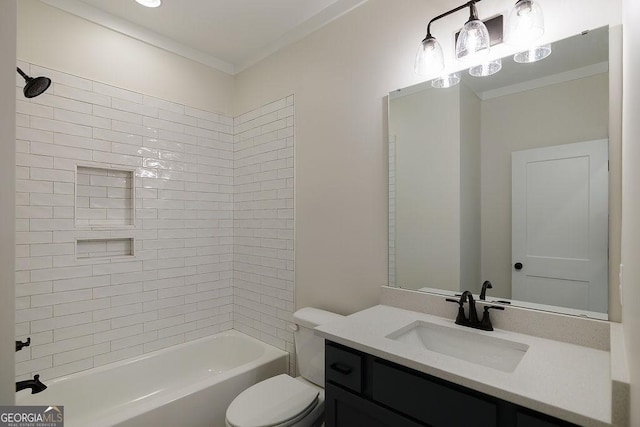 full bathroom with ornamental molding, toilet, vanity, and tiled shower / bath