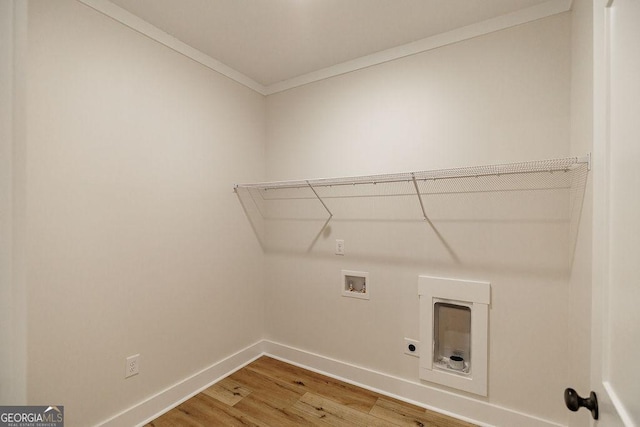 washroom with ornamental molding, hardwood / wood-style floors, washer hookup, and electric dryer hookup