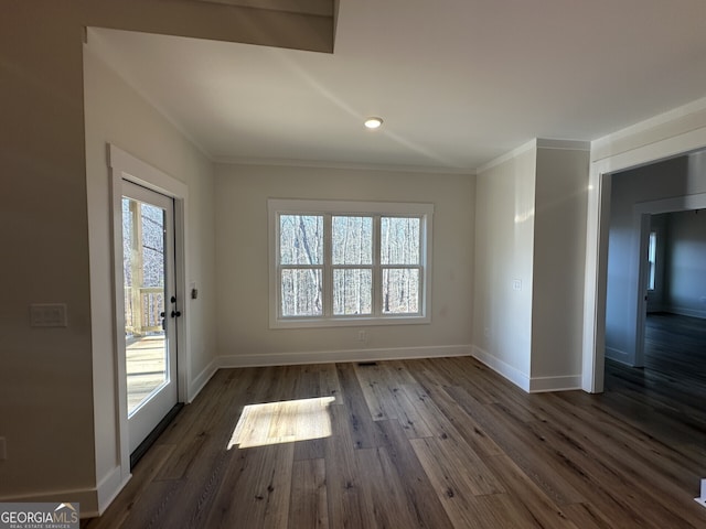 interior space with ornamental molding, a healthy amount of sunlight, and dark hardwood / wood-style flooring