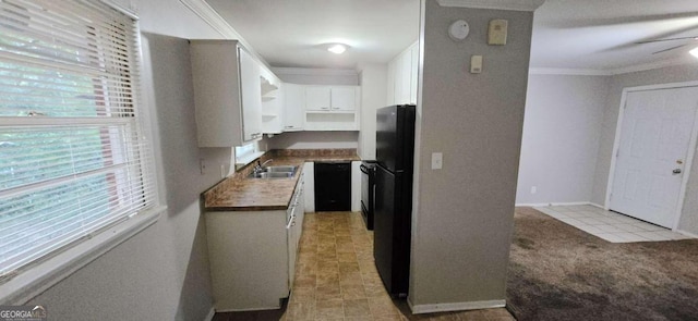 kitchen featuring ceiling fan, black fridge, white cabinetry, wood counters, and crown molding