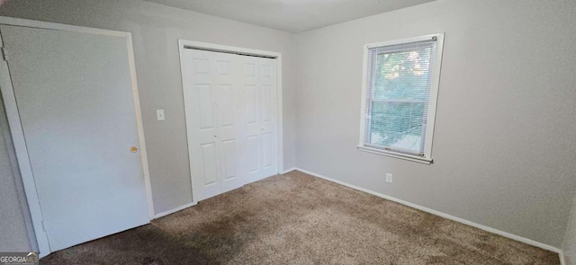 unfurnished bedroom with a closet and carpet floors