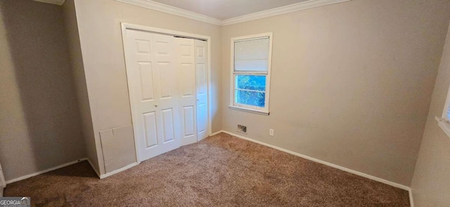 unfurnished bedroom with ornamental molding, carpet floors, and a closet