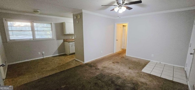 unfurnished bedroom featuring ornamental molding, a textured ceiling, light colored carpet, and ceiling fan