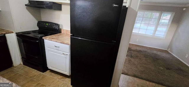 kitchen featuring black appliances, white cabinetry, light carpet, crown molding, and extractor fan