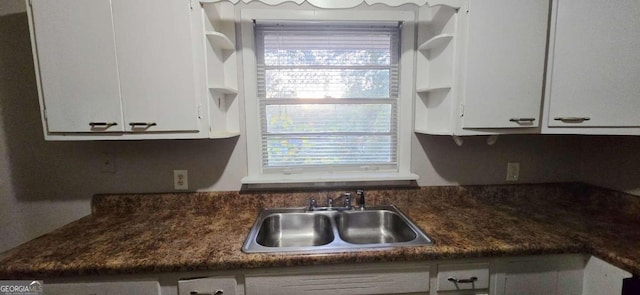 kitchen with white cabinetry and sink