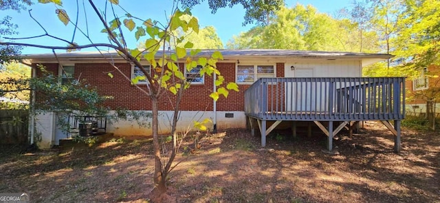 rear view of property featuring a deck