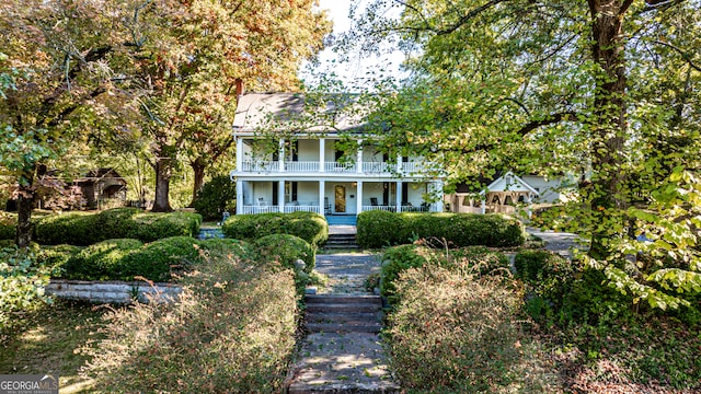 view of front of house with covered porch and a balcony