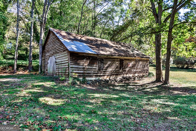 exterior space with a shed and a lawn