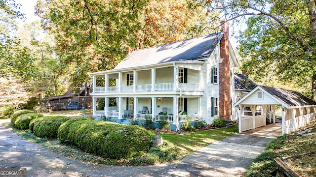 164 Manning Gin Rd, Bethlehem, GA 30620 - view of front of property featuring covered porch, a balcony, a chimney, and asphalt driveway