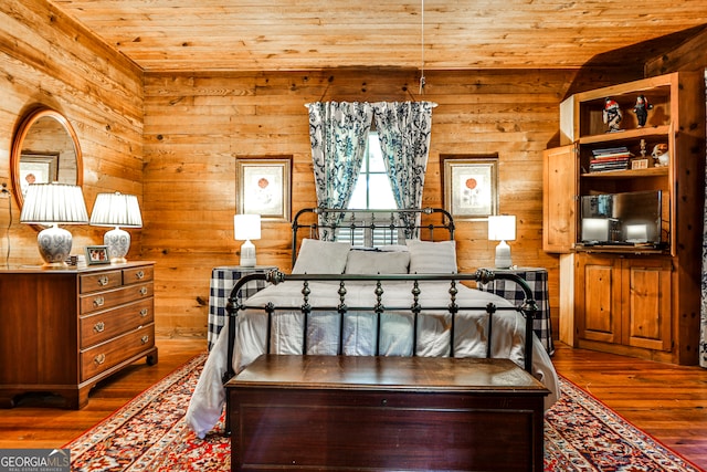 bedroom with dark wood-type flooring, wooden ceiling, and vaulted ceiling