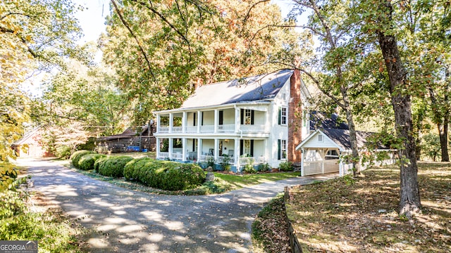 view of front of property featuring a balcony and covered porch