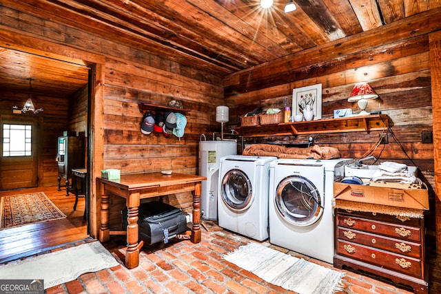 laundry area with wood walls, wooden ceiling, separate washer and dryer, and water heater