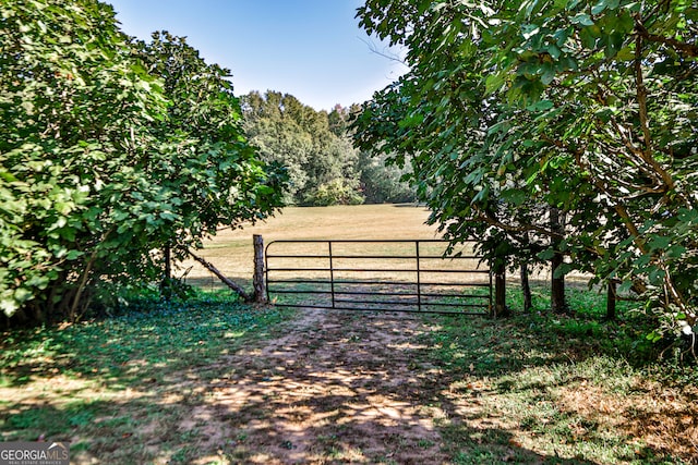 view of gate with a rural view