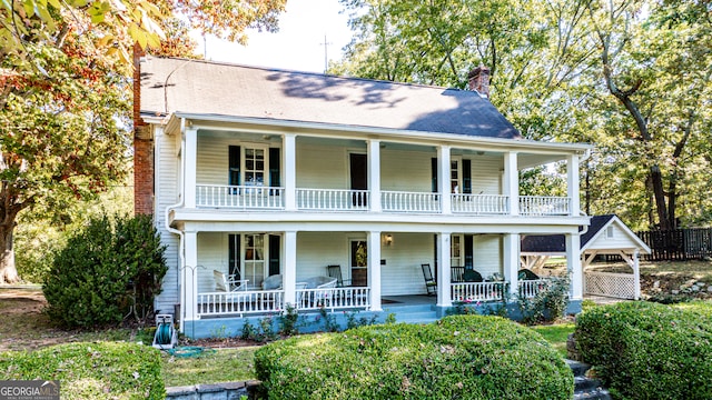 view of front of home with a porch and a balcony