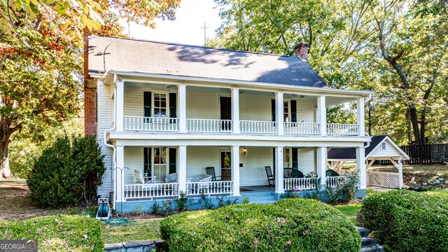 164 Manning Gin Rd, Bethlehem, GA 30620 - view of front facade with a balcony, a chimney, and a porch