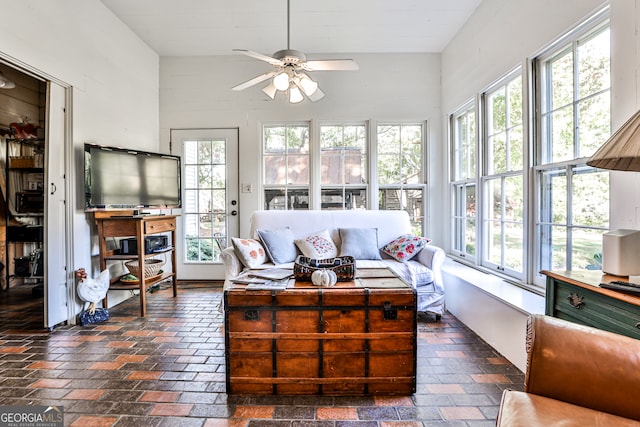 sunroom / solarium featuring ceiling fan