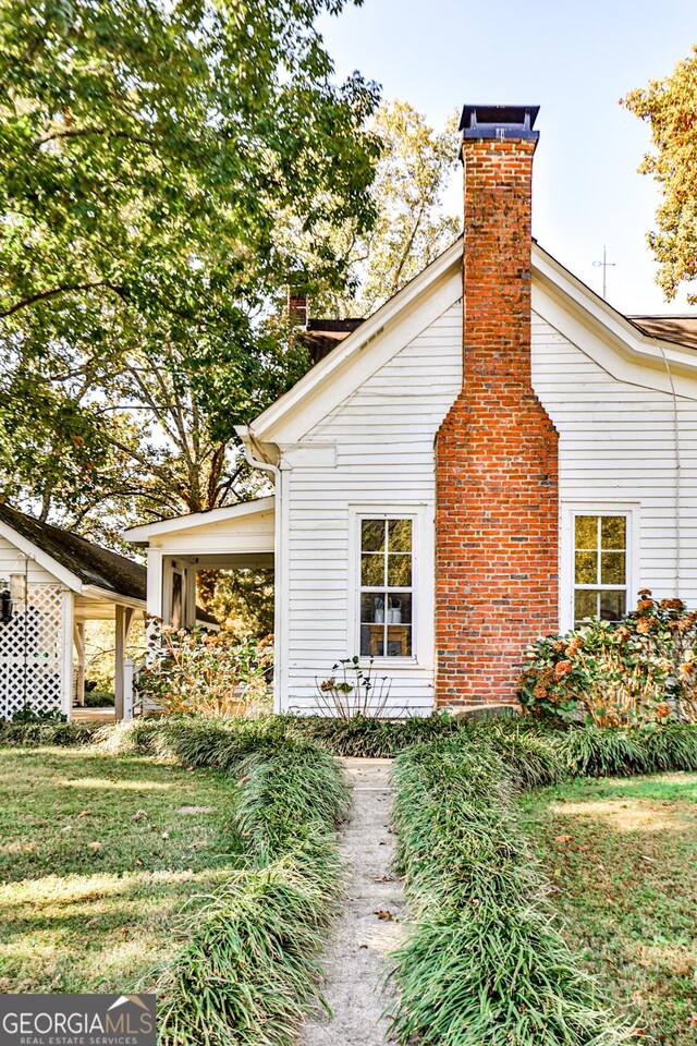164 Manning Gin Rd, Bethlehem, GA 30620 - view of side of home with a chimney and a yard
