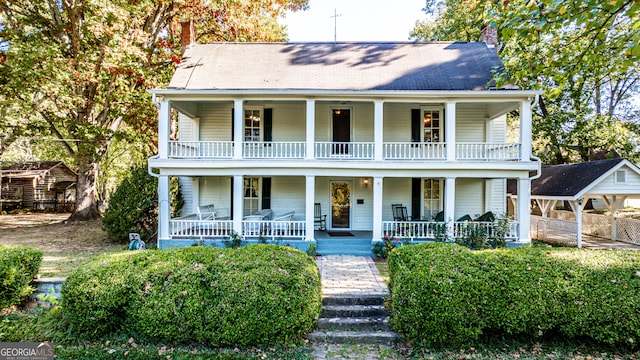 view of front of home featuring covered porch and a balcony