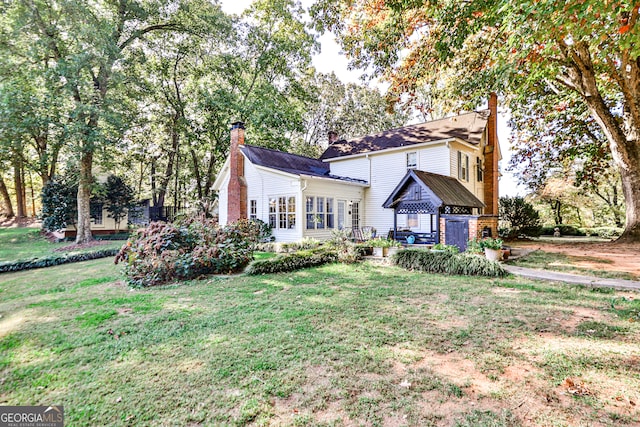 view of front of property with a gazebo and a front lawn