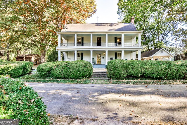 164 Manning Gin Rd, Bethlehem, GA 30620 - view of front facade featuring covered porch, a chimney, and a balcony