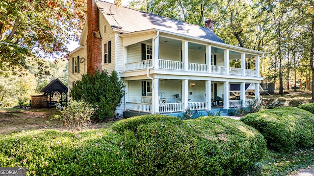 view of front of house featuring a balcony, a gazebo, and a porch