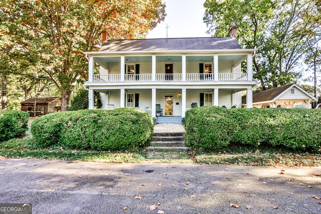 164 Manning Gin Rd, Bethlehem, GA 30620 - greek revival inspired property with covered porch, a chimney, an outbuilding, and a balcony