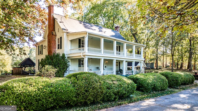 view of front of house with covered porch and a balcony