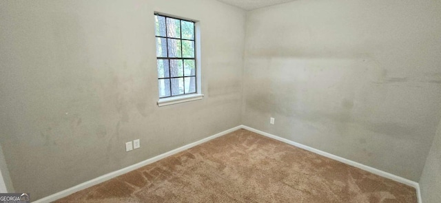 carpeted empty room with baseboards