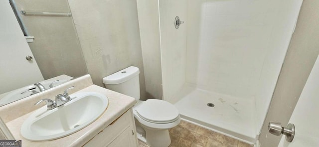 full bathroom featuring vanity, toilet, and a stall shower