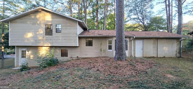 back of house featuring fence