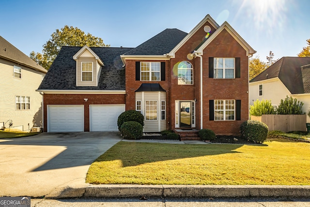 view of front property featuring a front yard and a garage