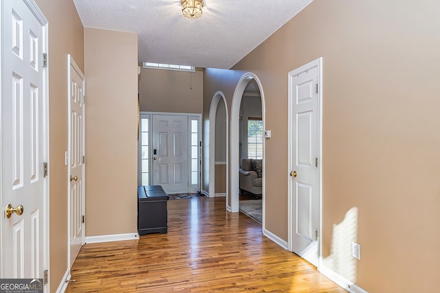 entrance foyer featuring wood-type flooring and a textured ceiling