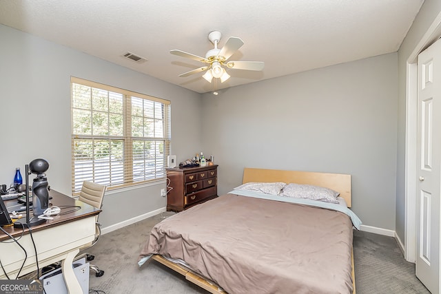 bedroom with a textured ceiling, carpet floors, and ceiling fan