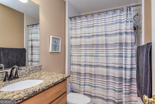 bathroom featuring vanity, toilet, and a shower with shower curtain