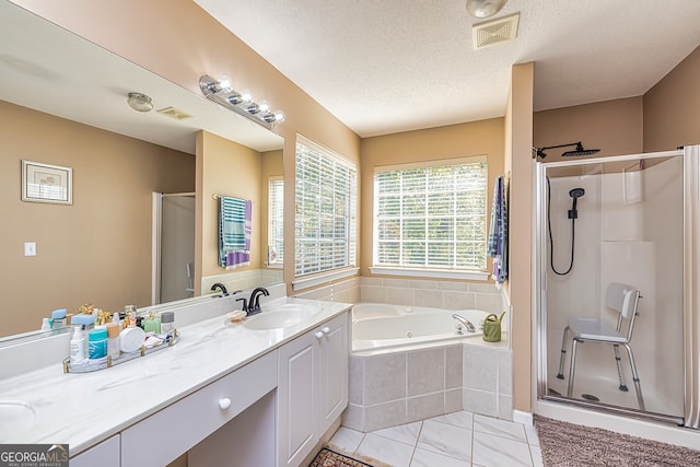 bathroom featuring vanity, a textured ceiling, and shower with separate bathtub