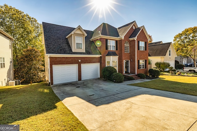 view of front property with cooling unit, a garage, and a front lawn