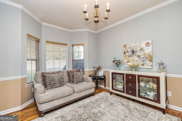 living room featuring crown molding, hardwood / wood-style flooring, and a notable chandelier