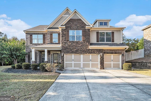 craftsman-style house with a front yard and a garage