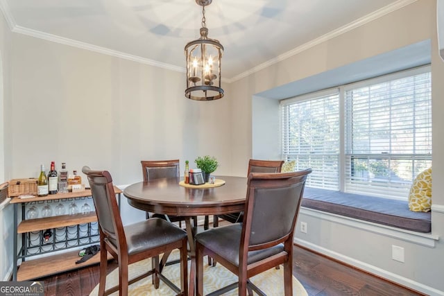 dining space featuring ornamental molding, a notable chandelier, and hardwood / wood-style floors