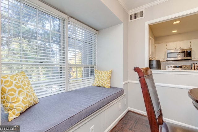 bedroom with crown molding, dark wood-type flooring, and multiple windows