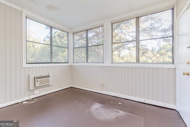 unfurnished sunroom featuring a healthy amount of sunlight and a wall unit AC